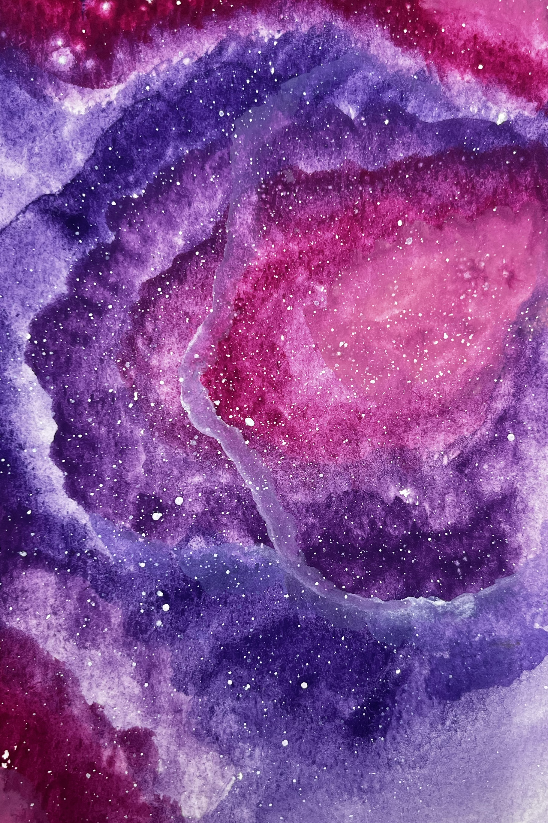 Pink and purple circular galaxy with stars